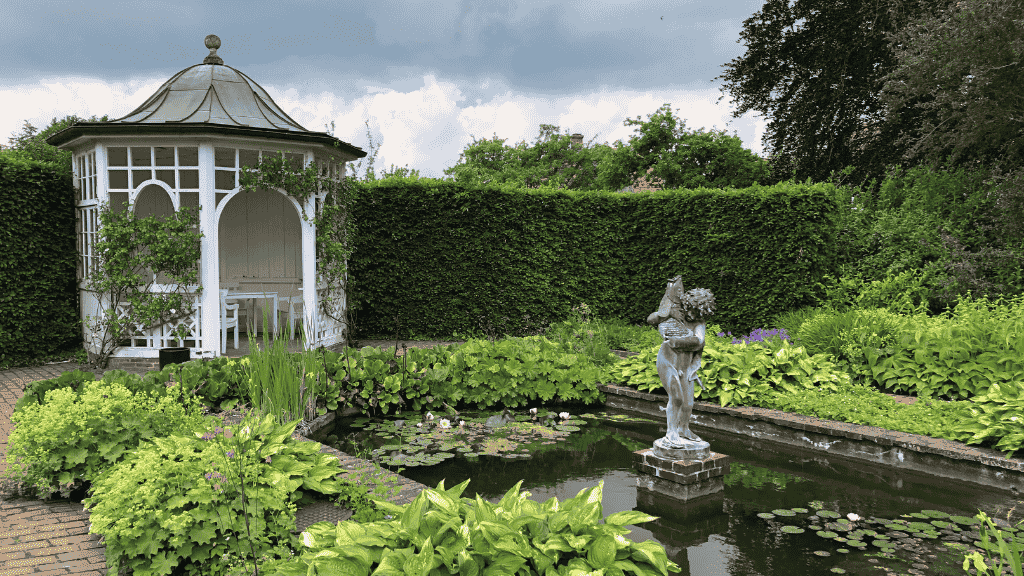 The Postmaster’s Garden in Aabenraa, featuring a fountain and a white pavilion.